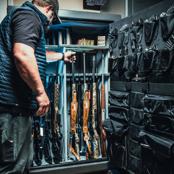 Man opening safe full of guns